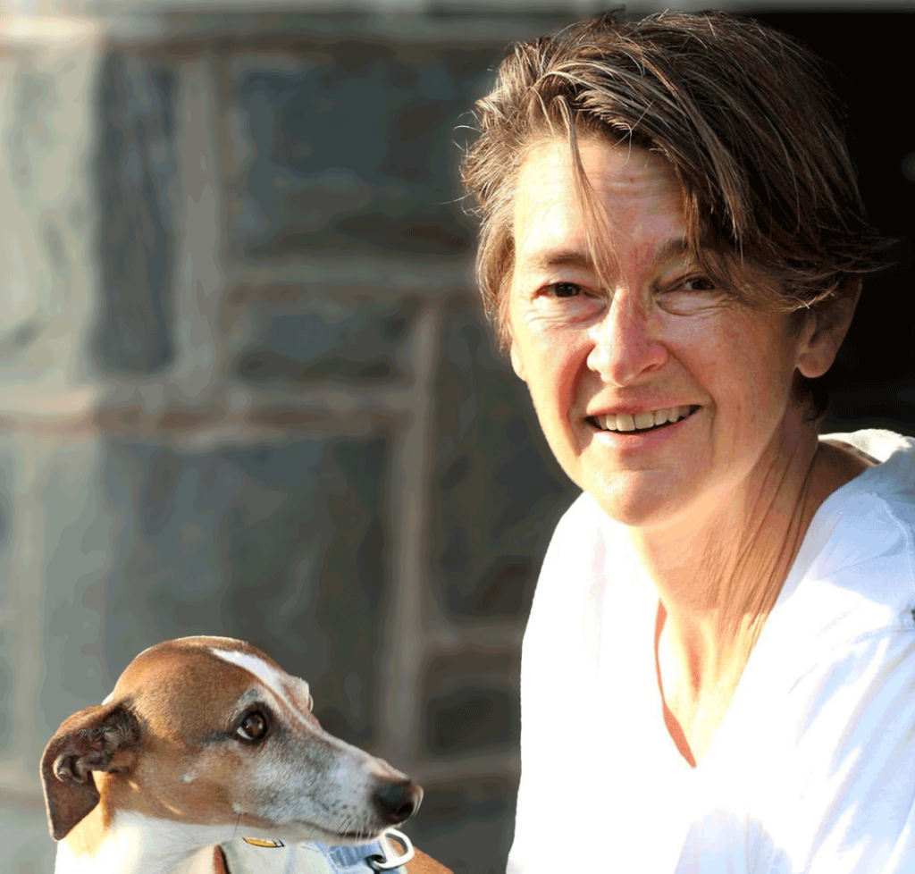 person kind of smiling at the camera with small dog.